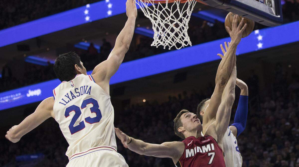 The Miami Heat's Goran Dragic (7) gets his shot blocked by Philadelphia 76ers' Ben Simmons, right, with Ersan Ilyasova, left, defending during the first half Tuesday, April 24, 2018, in Philadelphia.