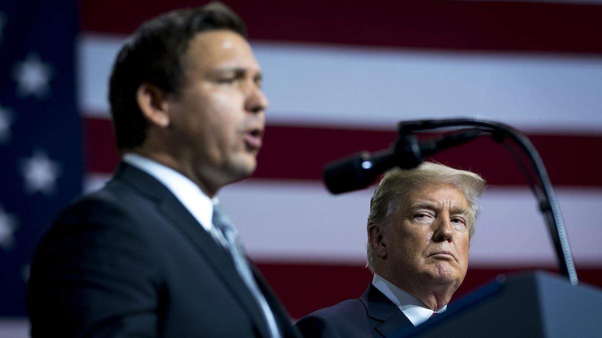 President Donald Trump looks on as Ron DeSantis, a Republican candidate for Florida governor, speaks at a Make America Great Again rally at a fairground auditorium in Tampa, on Tuesday, July 31, 2018.