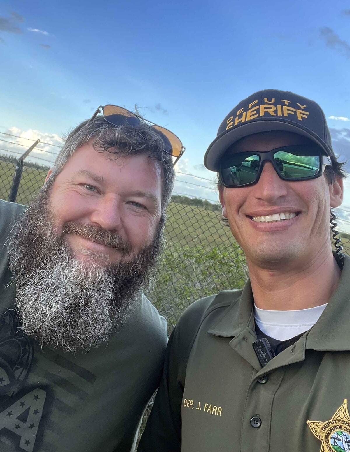Tre Huntoon, who was featured on Animal Planet’s ‘Gator Boys’ reality TV show, poses with Monroe County Sheriff’s Office Deputy Jason Farr Monday, June 5, 2023, after the two helped capture an alligator on the 18 Mile Stretch of U.S. 1 heading into the Florida Keys.