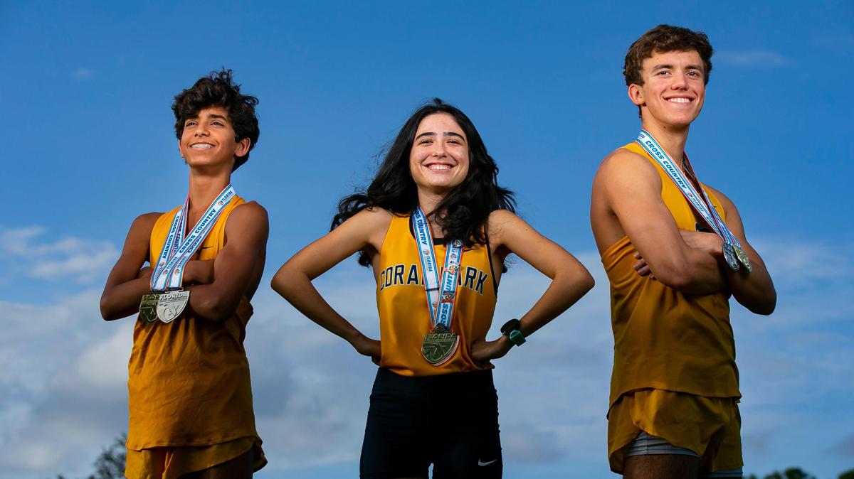 From left to right: Dade Cross Country Players of the Year Joshua Ruiz, from Belen Jesuit Preparatory School, Penelope Sosa, from Coral Park, and Adam Magoulas, from Belen Jesuit Preparatory School, are photographed at A.D. Barnes Park in Miami, Florida on Wednesday, January 12, 2022.