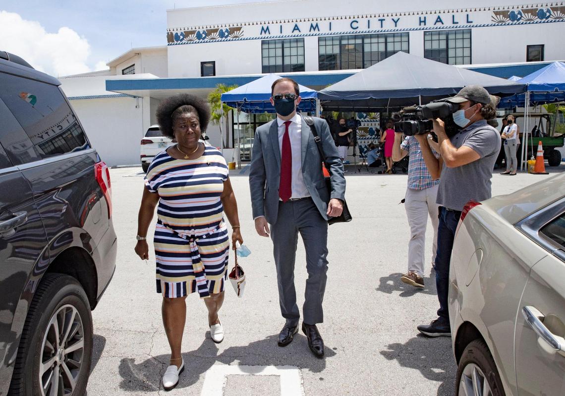 From left to right: Attorney Matthew Baldwin and Miami code inspector Suzann Nicholson leave after speaking outside Miami City Hall on Thursday, April 29, 2021, about a defamation lawsuit they filed against Commissioner Alex Diaz de la Portilla. They accuse the commissioner of libel after he accused her of fabricating a physical altercation with him in order to claim workers compensation.