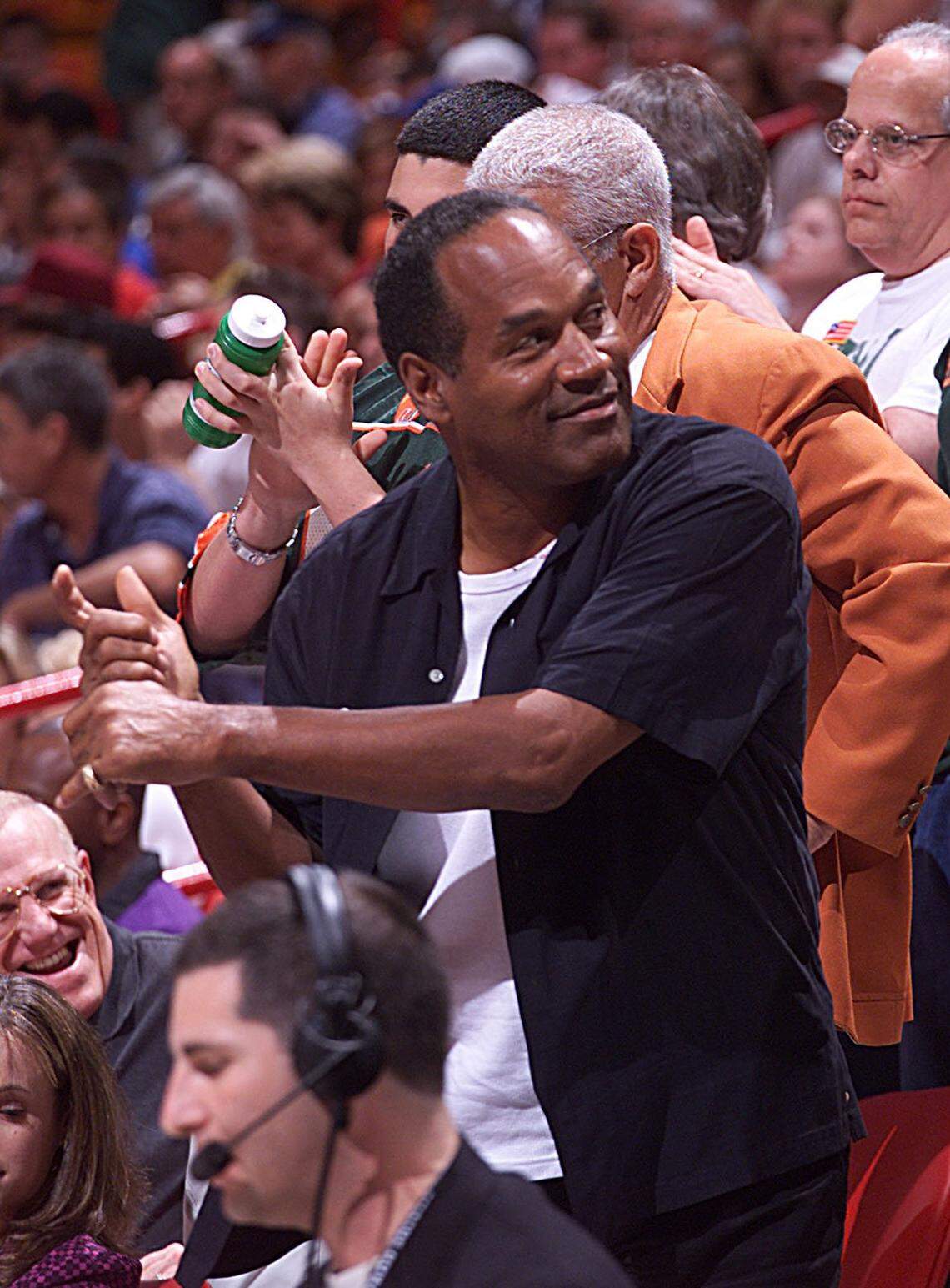 In 2001, O.J. Simpson practices his golf swing while in the stands of the UM-Indiana basketball game at the downtown Miami arena.