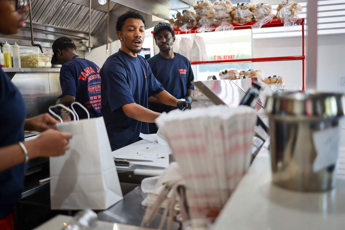 Miami native Siddiq Kancey, center, prepares cheesesteak sandwiches with his staff for the lunchtime rush at Tanya Jo’s Cheesesteaks on Thursday, Oct. 15, 2026.