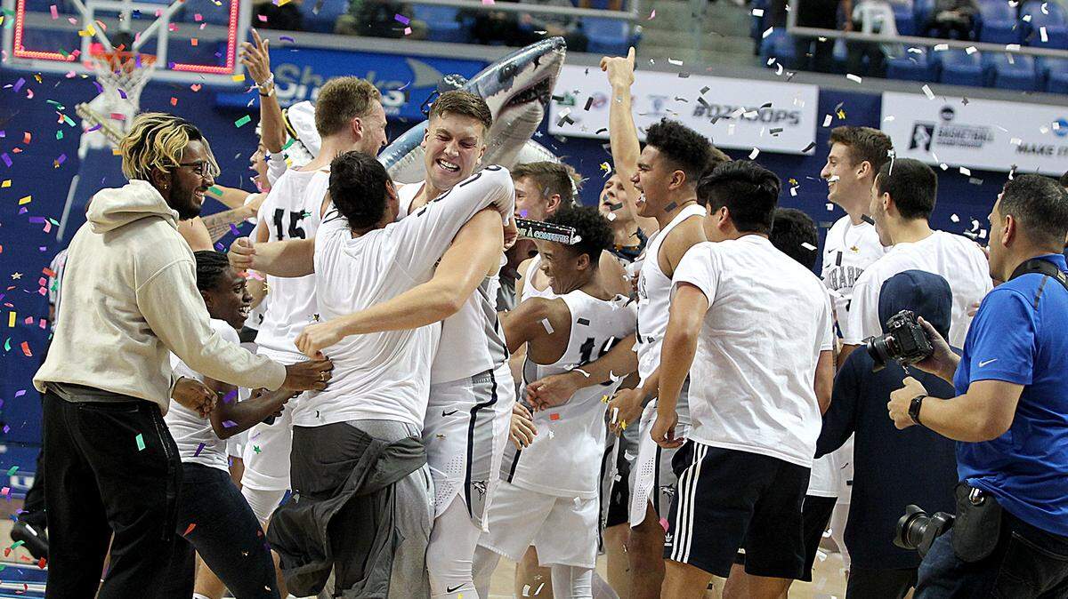 Nova Southeastern University’s Sharks celebrated their 89-74 victory against the Lynn University’s Knights to win the NCAA Division II south region championship at the Rick Case Arena.