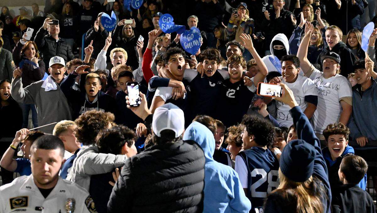 Gulliver Prep players celebrate in the stands after crashing through the barriers to join family, friends and fans after winning the Class 4A boys soccer state championship on Saturday at Lake Myrtle Park in Auburndale.