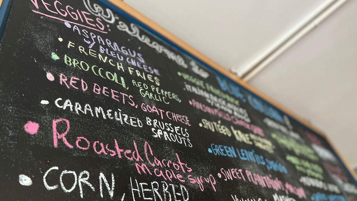 The menu board at Blue Collar restaurant in Miami’s MiMo neighborhood is moving — across the street.