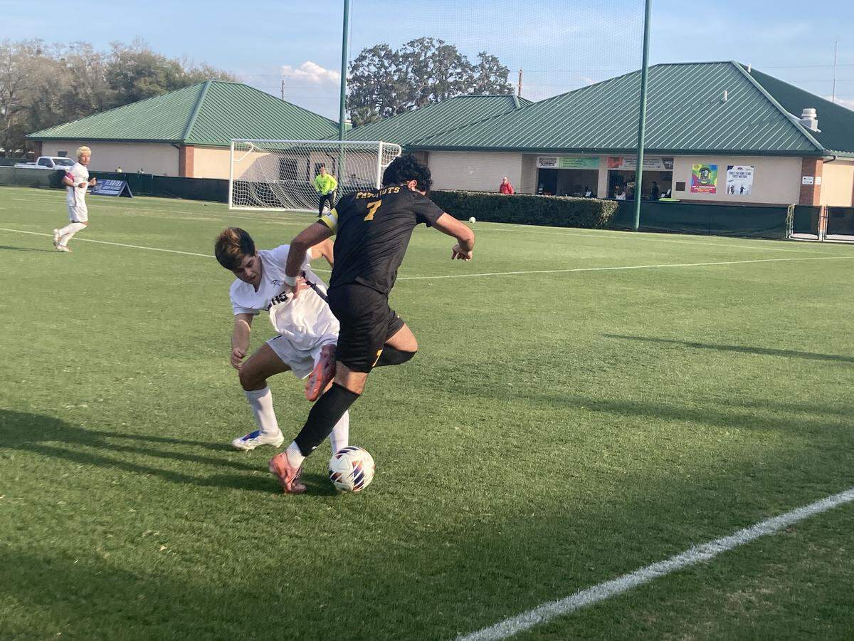 American Heritage’s Gianluigi Gonzalez (7) battles a Fort Walton Beach defender for possession during Thursday’s Class 4A state boys soccer semifinal at Spec Martin Stadium in DeLand, Fla.