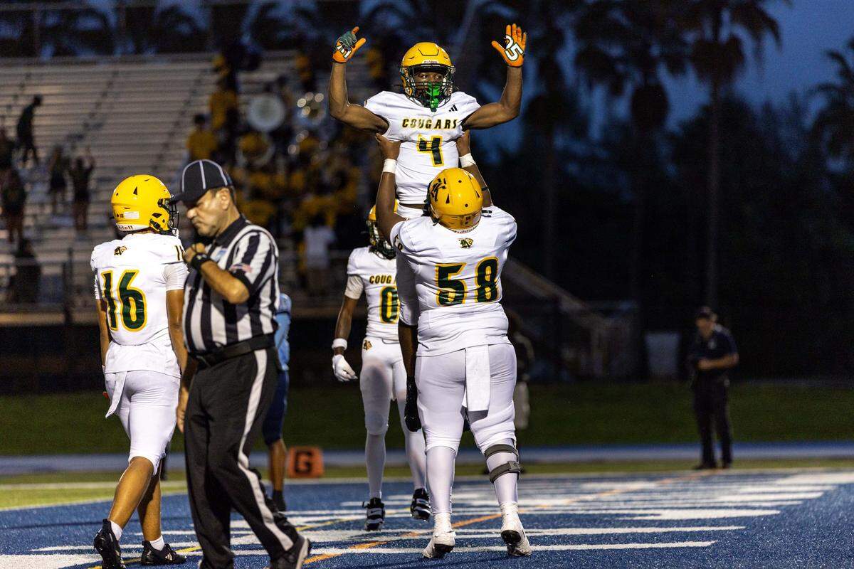 Killian High School guard Darrin McGuire Jr. (58) lifts running back Kayron Bryant (4) after he scored a touchdown during a high school football game against Palmetto High School at Tropical Park on Thursday, September 18, 2025, in West Park, Fla.
