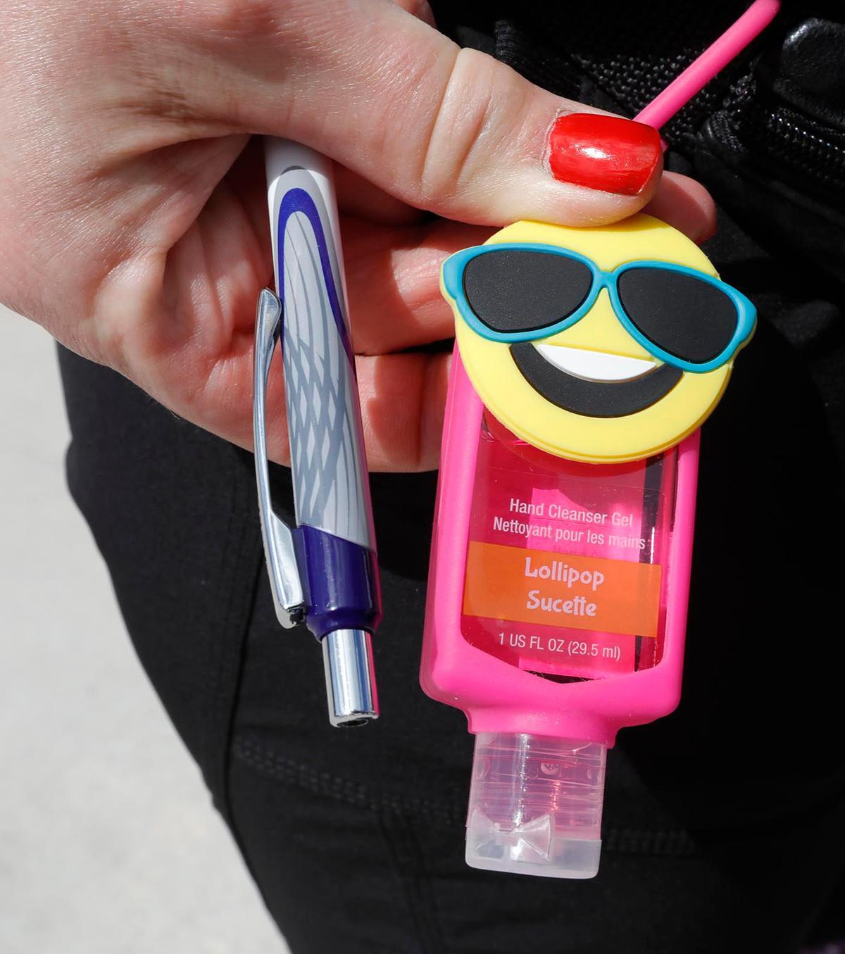 Yvonne Rolland, a Carnival Cruise Line passenger from Canada, holds a hand sanitizer at the Port of Miami.