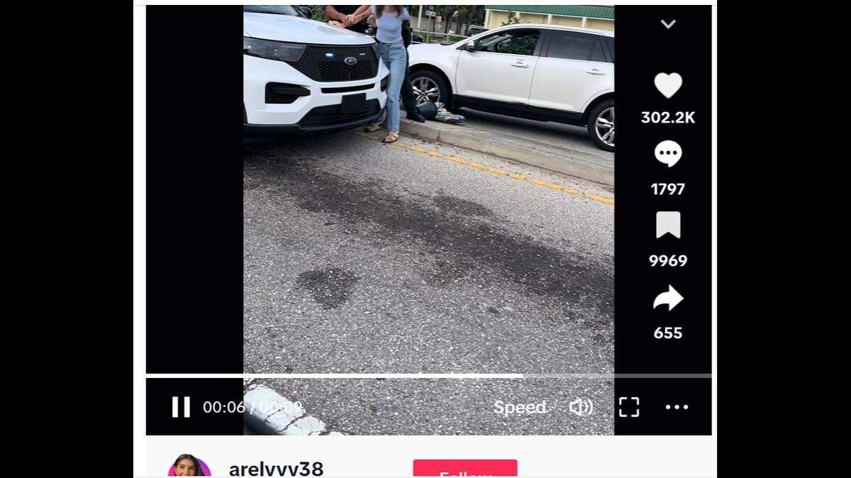 Video of a Florida woman’s arrest is going viral after she tried to give money to a lady selling flowers on the side of the road on Imperial Parkway in Bonita Springs/TikTok screenshot