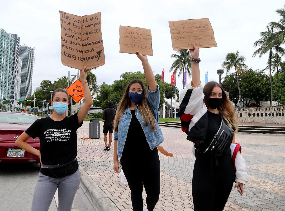 On day six of protests in downtown Miami in response to the police killing of George Floyd in Minneapolis, including students from left-Zoe Cross, University of Miami, Amanda Caban, at University of North Florida and Costanza Musetti at Florida International’s University, began blocking one lane of traffic on Biscayne Boulevard at Northeast Third Street around 5:15 p.m. Thursday, on Thursday, June 04, 2020.