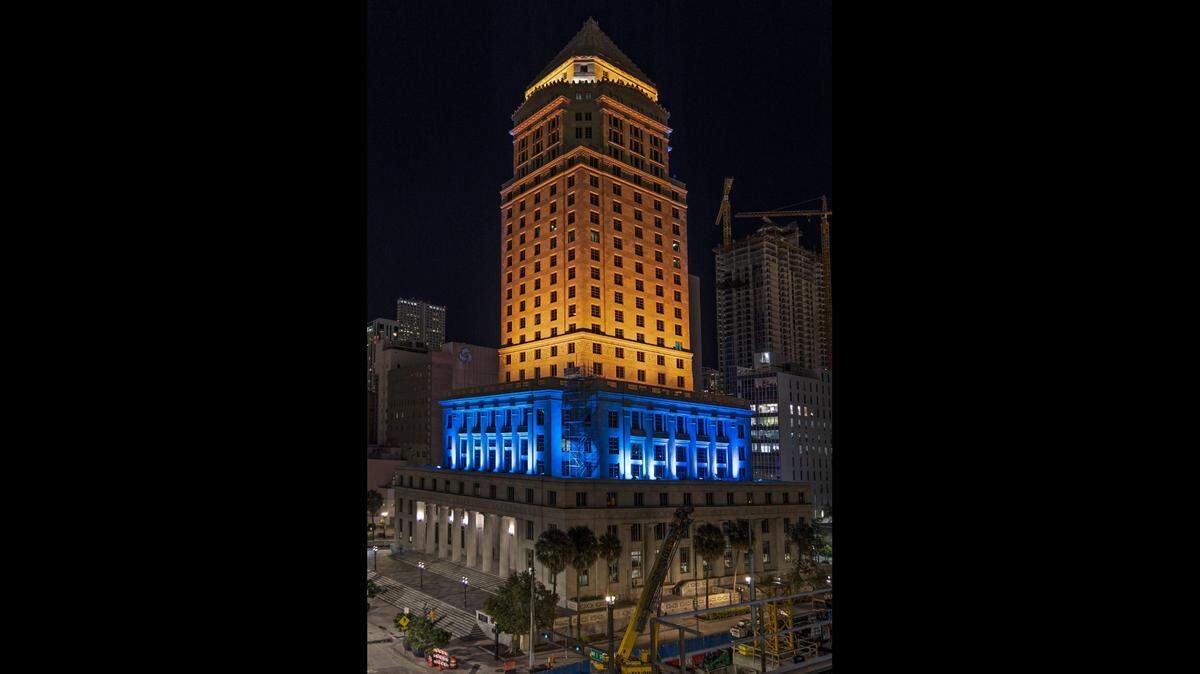 Miami-Dade County’s courthouse is lit in the colors of yellow and blue in solidarity with Ukraine on Monday, February 28, 2022 in downtown Miami, Florida.