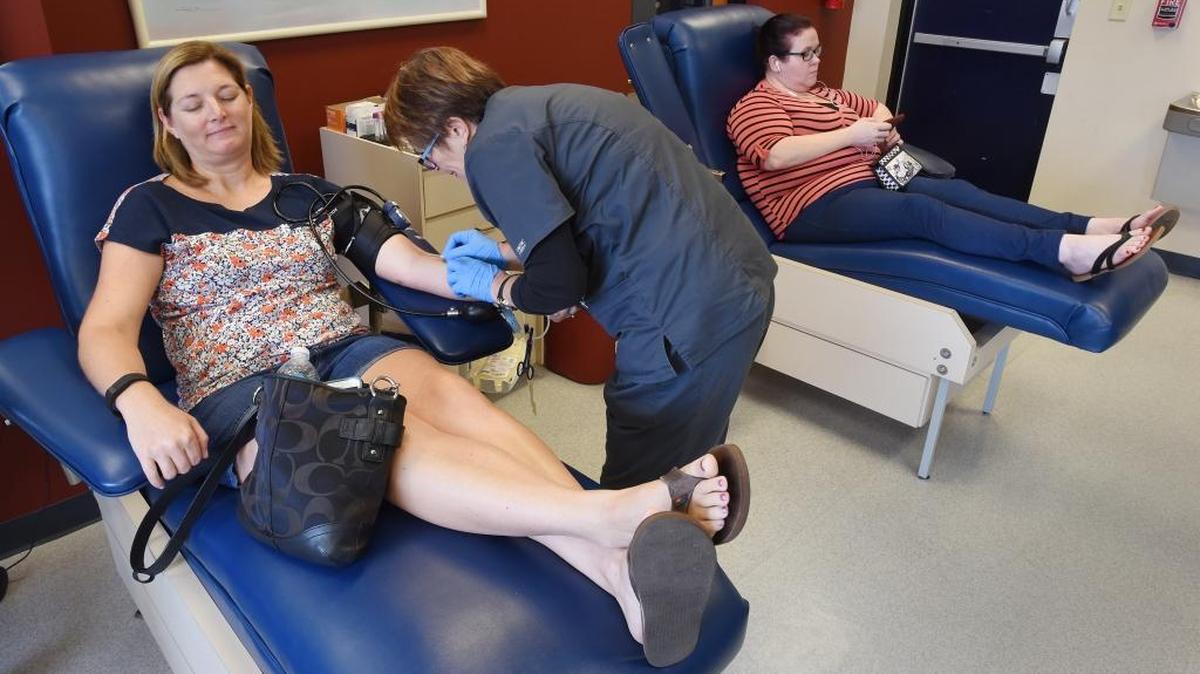 Aimee McCarthy from Jacksonville gives blood at a facility in that city on Sunday. Blood banks in Orlando quickly filled to capacity as donors lined up by the hundreds to help survivors.