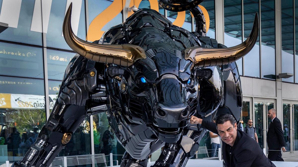 Miami Mayor Francis Suarez poses Wednesday with the “Miami Bull” statue at the Miami Beach Convention Center. 
