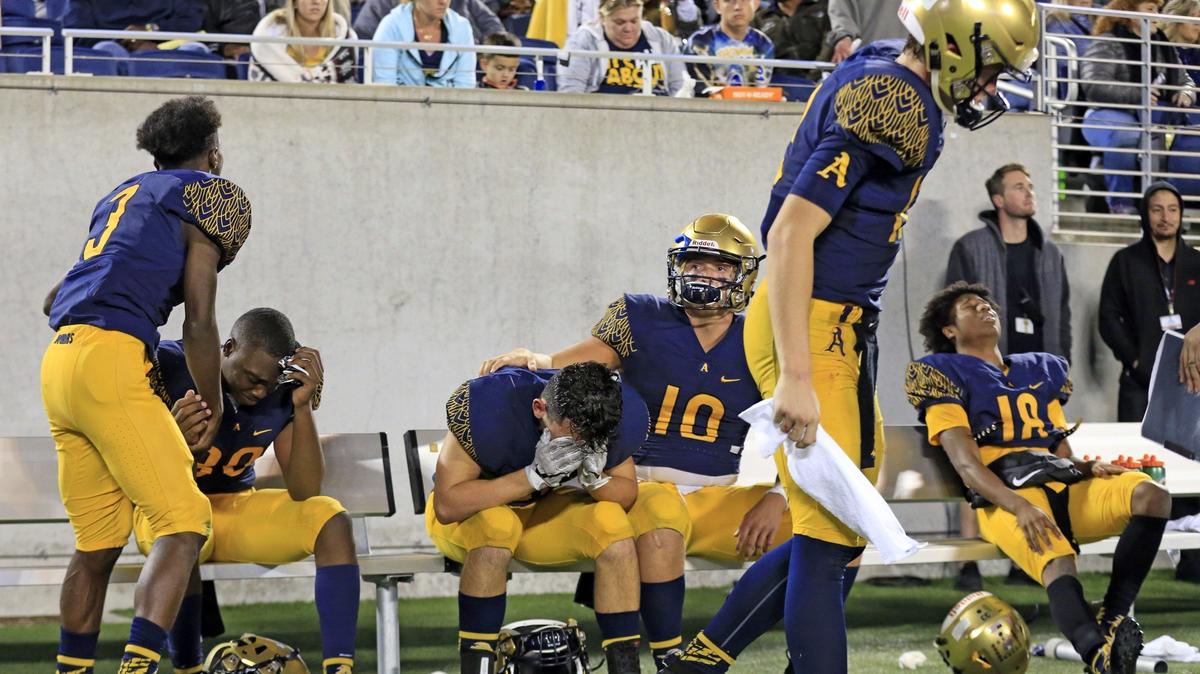 St. Thomas Aquinas Raiders players react after being defeated by the Lakeland Dreadnaughts during the Florida High School Athletic Association State Championship Class 7A at Camping World Stadium in Orlando on Friday, December 7, 2018.