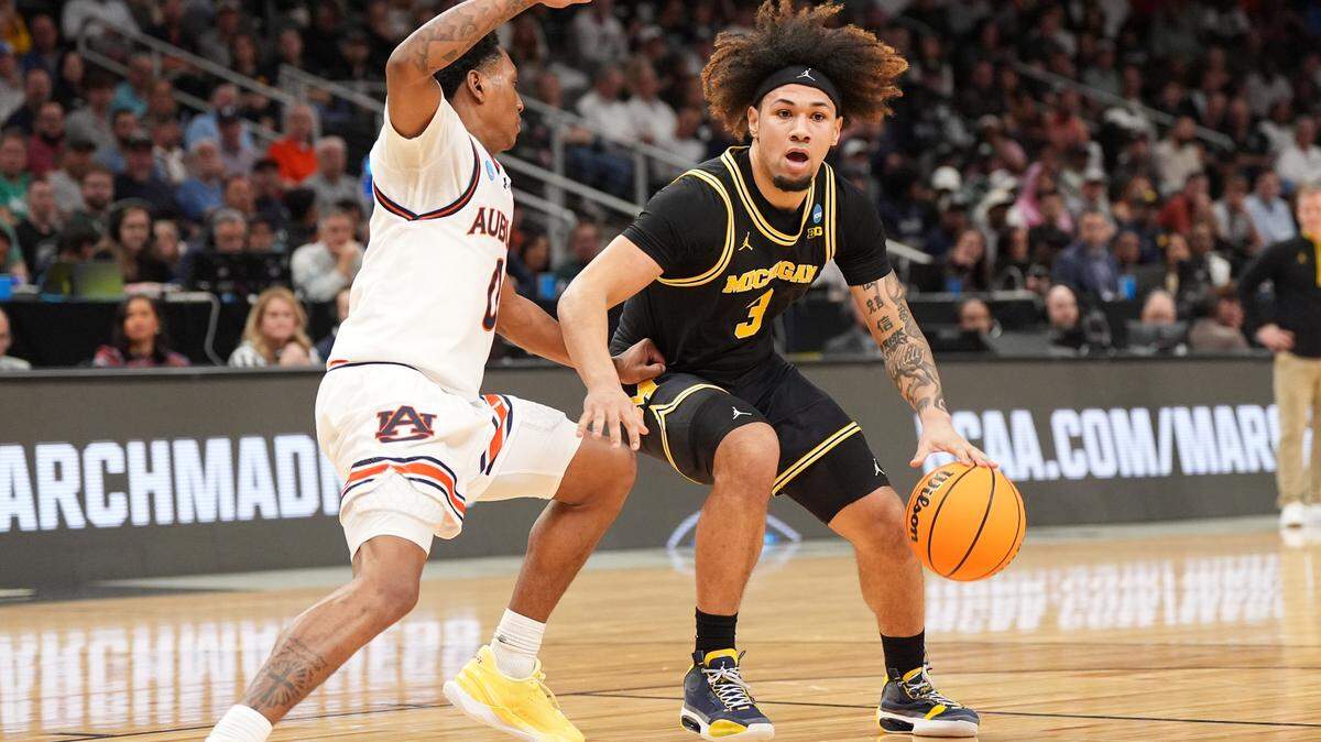 Mar 28, 2025; Atlanta, GA, USA; Michigan Wolverines guard Tre Donaldson (3) dribbles against Auburn Tigers guard Tahaad Pettiford (0) in the first half of a South Regional semifinal of the 2025 NCAA tournament at State Farm Arena. Mandatory Credit: Dale Zanine-Imagn Images