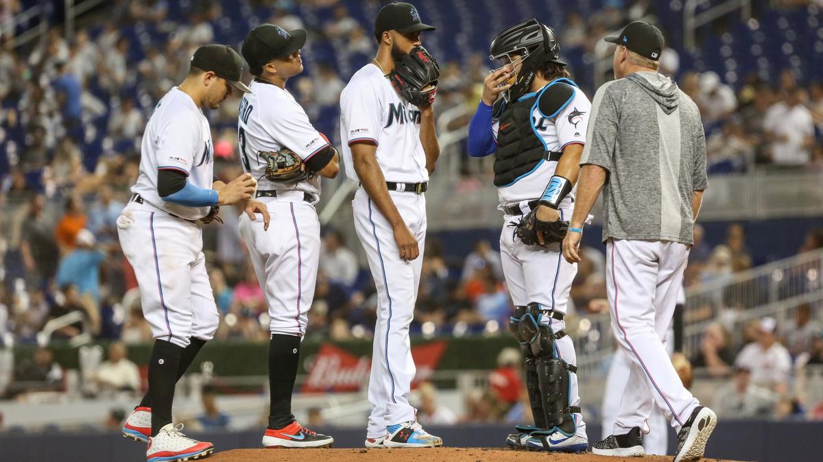 Miami Marlins pitching coach Mel Stottlemyre Jr talks with pitcher Sandy Alcantara (22) on the mound during the third inning of an interleague Major League Baseball game at Marlins Park in Miami on Wednesday, July 31, 2019.