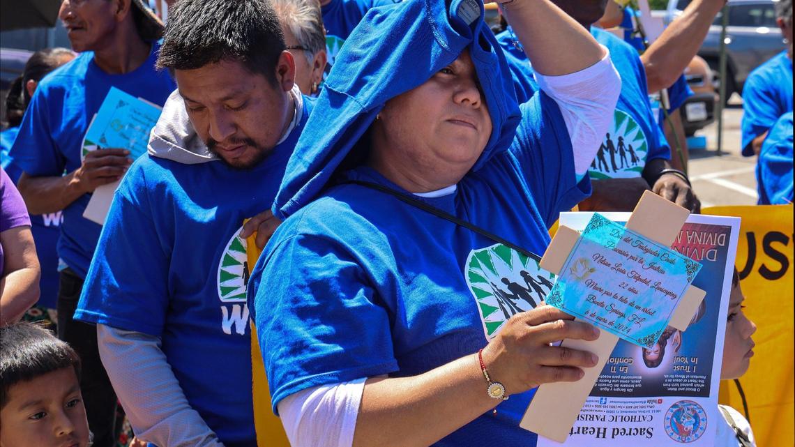 WeCount! members shield their heads with t-shirts and umbrellas from the heat prior to marching in honor of workers who have died due to extreme heat in Homestead, Florida on Sunday, April 27, 2025.