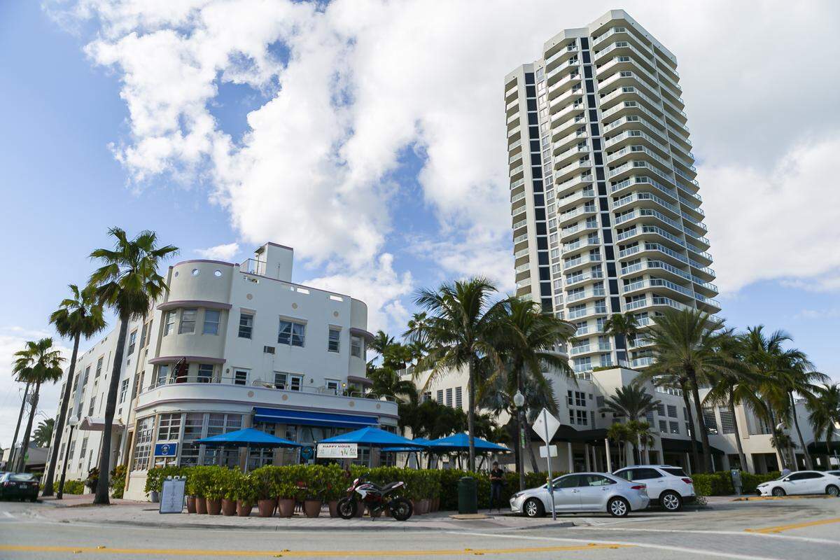 A view of the beachfront Ocean Terrace street in the North Beach section of Miami Beach shows a historic Streamline Moderne hotel at left and the more recent St. Tropez Ocean Front Condominium tower at right.
