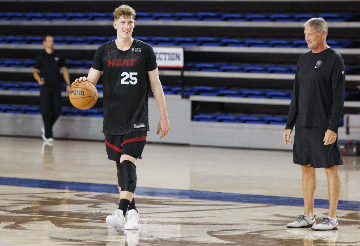 Kasparas Jakucionis (25) works with a coach during the second day of Miami Heat Training Camp on Oct. 1, 2025, at Florida Atlantic University in Boca Raton.