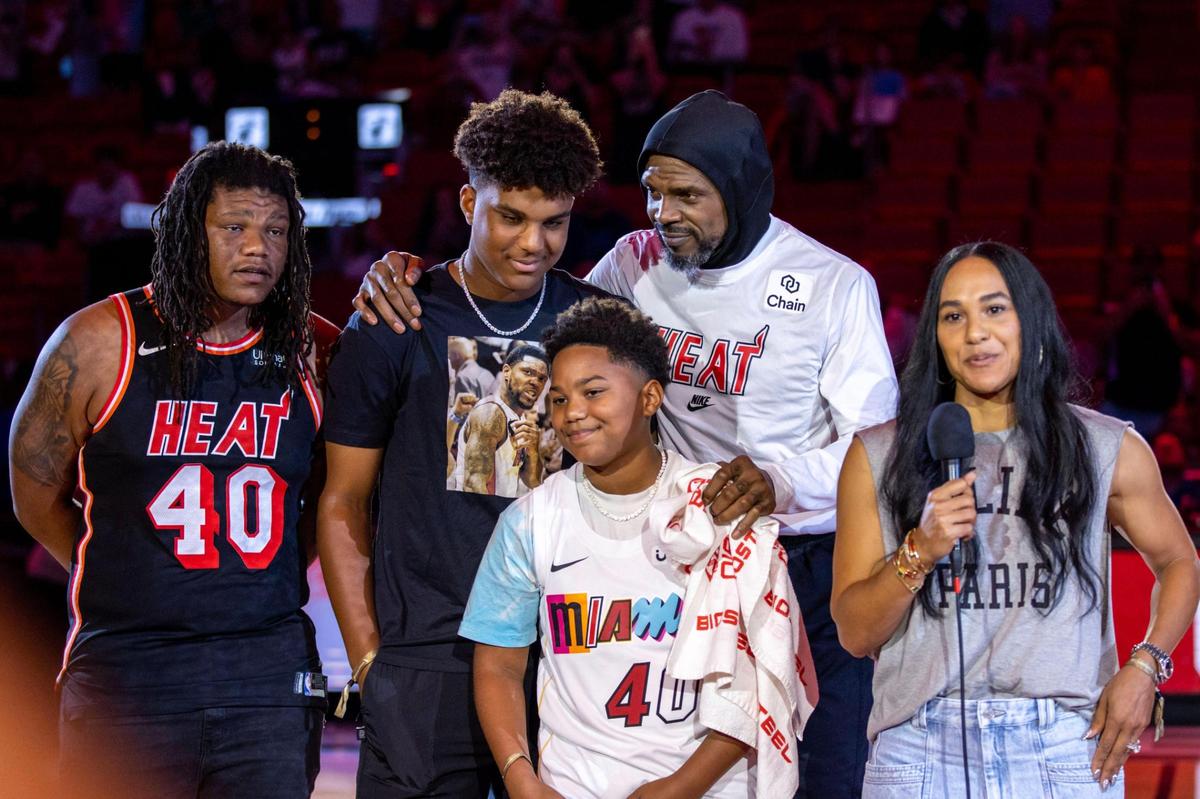 Miami Heat forward Udonis Haslem (40) stands with his children and wife , Faith Rein, as she speaks to the audience as Haslem is honored before playing his last regular season game with the organization during an NBA game against the Orlando Magic at Kaseya Center in Downtown Miami, Florida, on Sunday, April 9, 2023.