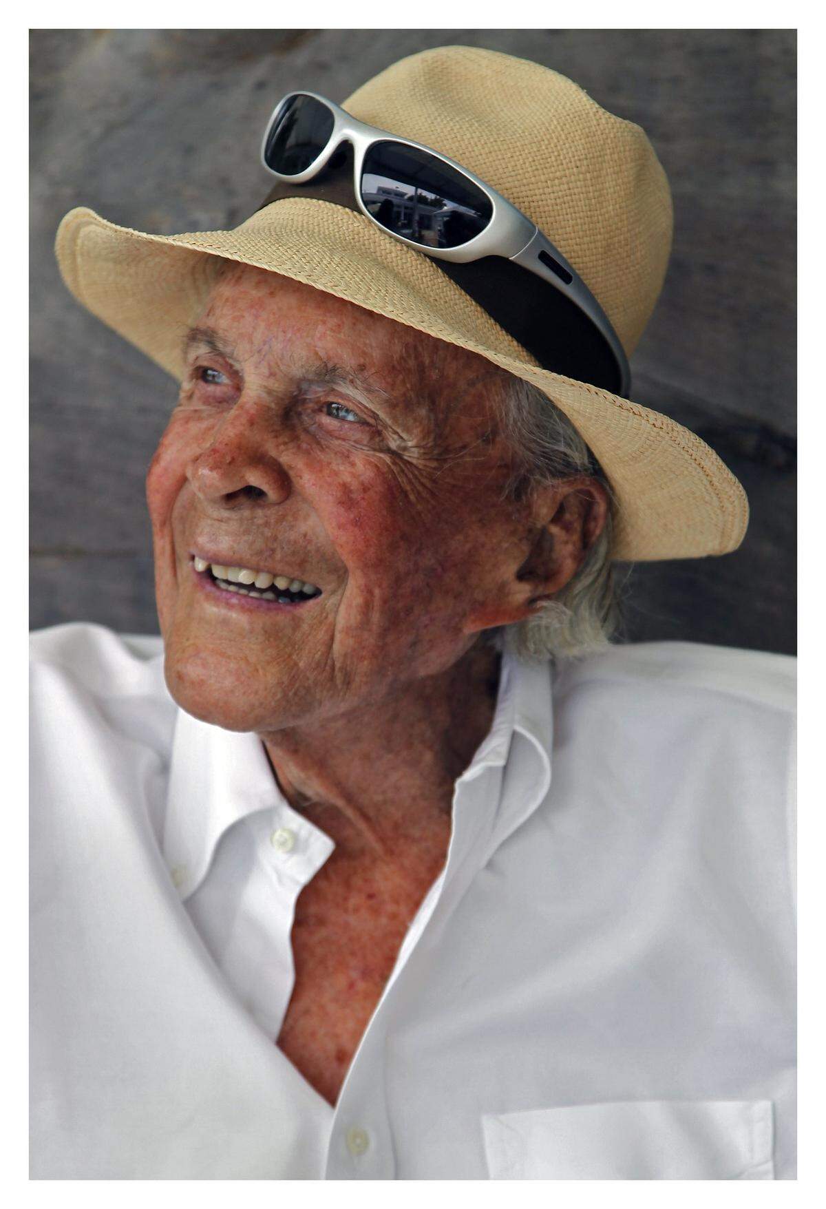 David Wolkowsky sits dressed in a stylish linen shirt and panama hat in Key West.
