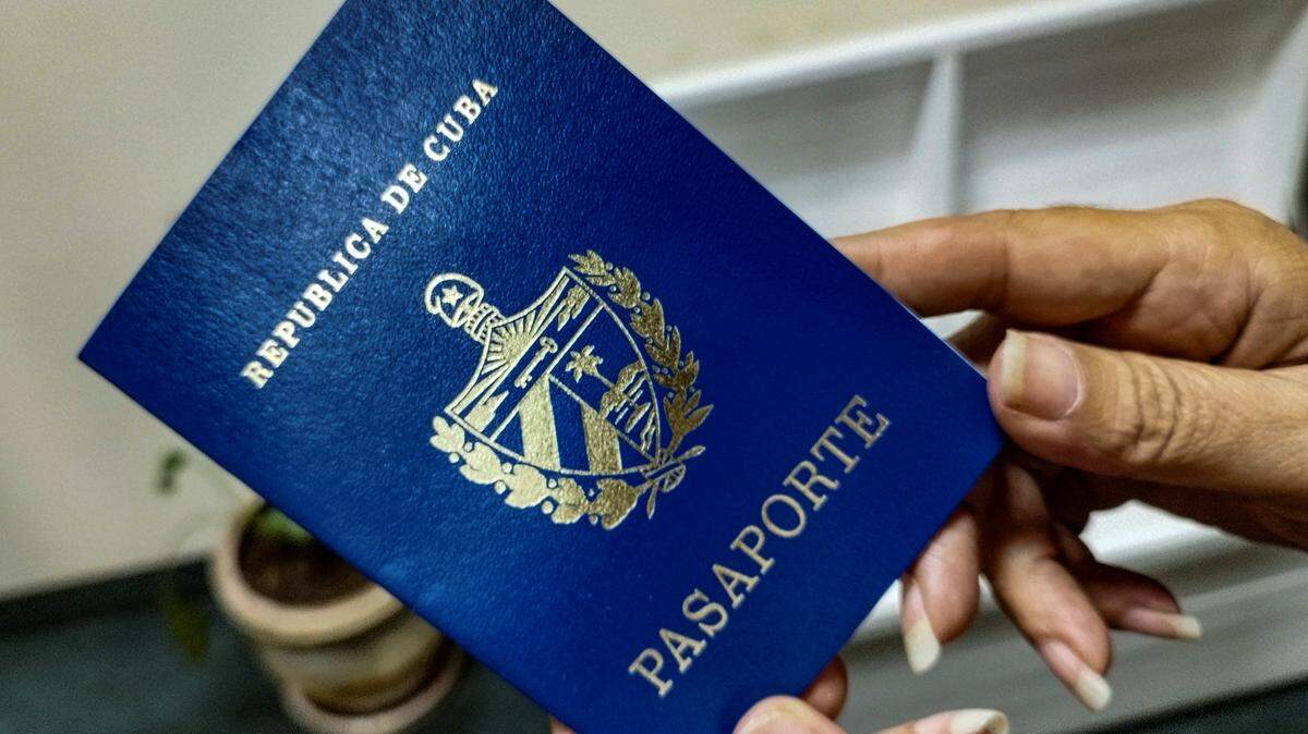 A woman holds her Cuban passport in Havana. 