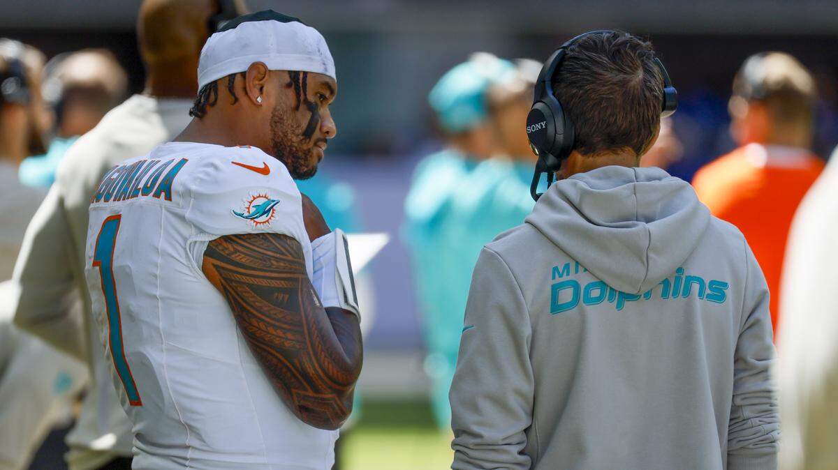 Miami Dolphins quarterback Tua Tagovailoa (1) talks with Miami Dolphins head coach Mike McDaniel during the first half of an NFL game against the Indianapolis Colts at Lucas Oil Stadium on Sunday, September 7, 2025, in Indianapolis, Indiana.