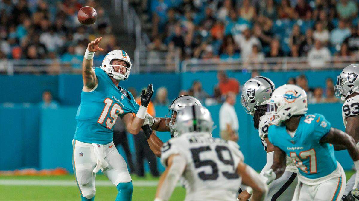 Miami Dolphins quarterback Skylar Thompson (19) throws a pass against the pressure of Las Vegas Raiders defensive end Myron Tagovailoa-Amosa (69) during fourth quarter of an NFL preseason football game at Hard Rock Stadium on Saturday, August 20, 2022 in Miami Gardens, Florida.