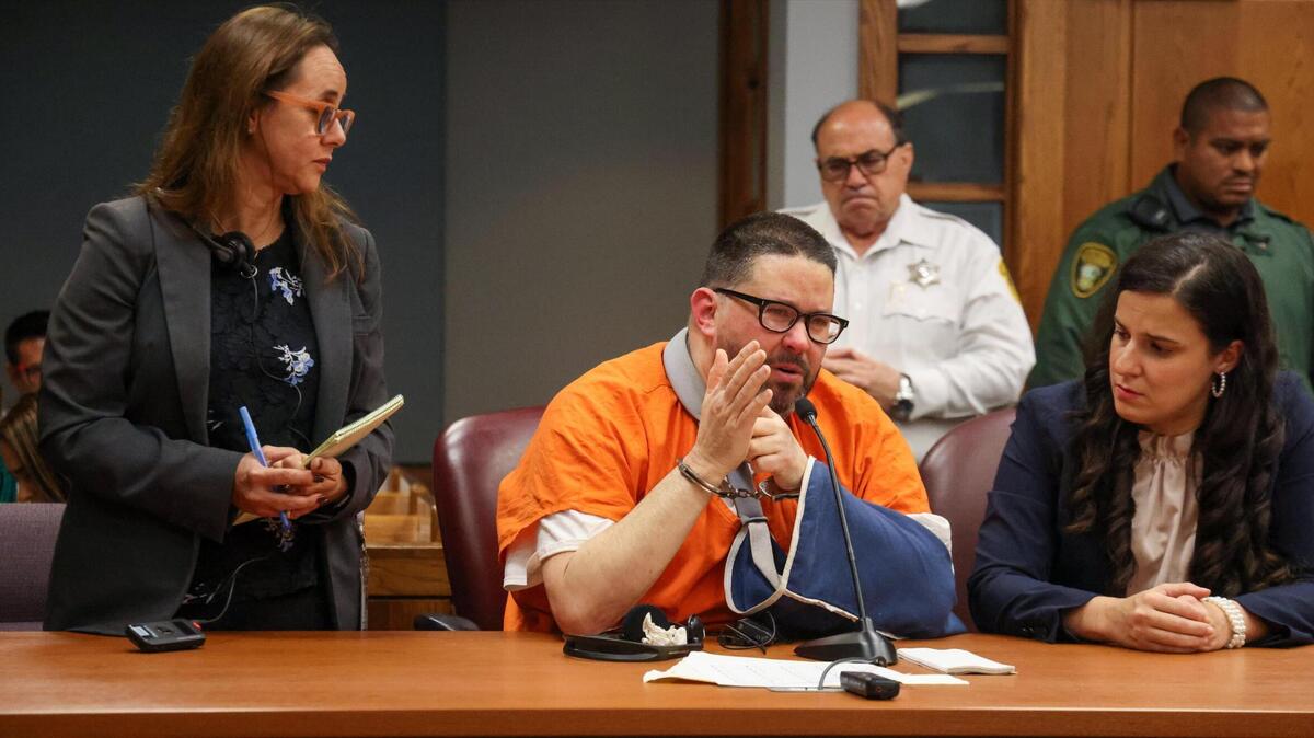 Through a court translator Maria Correal, left, Kadel Piedrahita, sitting next to his defense attorney Yanelis Zamora, right, addresses the court and the family of Alex Palencia regarding his remorse during his sentencing Thursday, Oct. 24, 2024, in Miami, Florida. Piedrahita was sentenced to life in prison for fatally shooting cyclist Alex Palencia on the Rickenbacker Causeway.