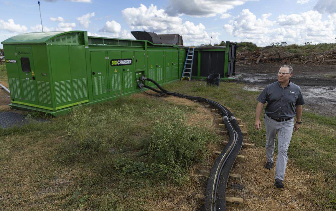Mike Schmitt, director of sales and marketing with Air Burners, walks past a BioCharger unit on Thursday, Jan. 8, 2026, in Palm City, Fla. Air Burners is a manufacturer of air curtain burner systems, which provide a controlled way to dispose of wood and other vegetative waste.