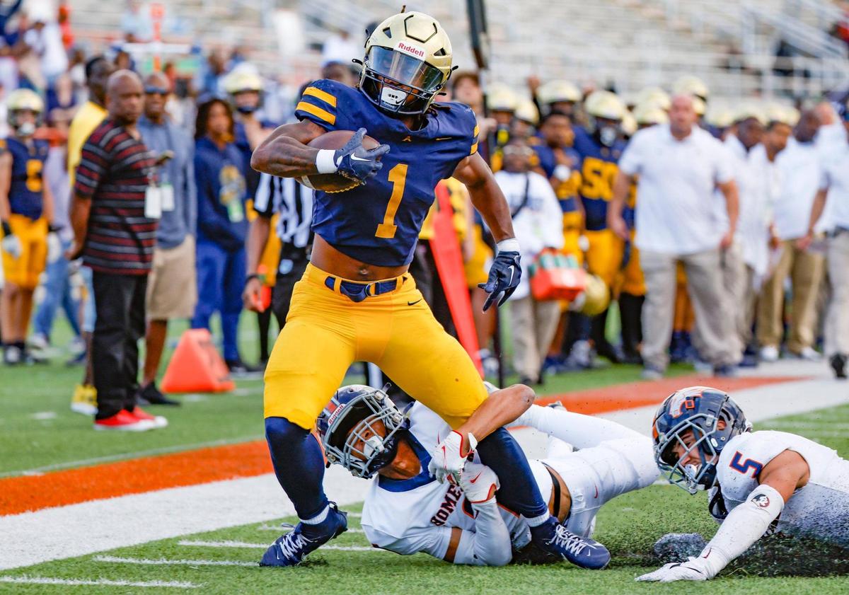 St. Thomas Aquinas running back Jordan Lyle (1) takes it to the goal line as Homestead Broncos Jakhai Rainey (9) makes the stop in the first half of the Class 3M state championship at Bragg Memorial Stadium in Tallahassee, Florida, on Saturday, December 9, 2023.