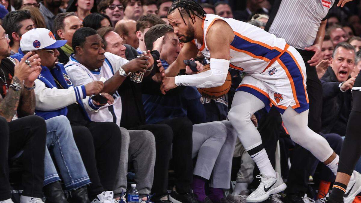 Nov 17, 2024; New York, New York, USA; New York Knicks guard Jalen Brunson (11) crashes into actor and comedian Tracy Morgan in the fourth quarter against the Brooklyn Nets at Madison Square Garden. Mandatory Credit: Wendell Cruz-Imagn Images