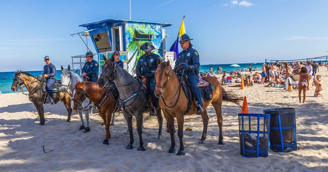 Fort Lauderdale Police mounted patrol surveys the scene as spring breakers enjoy the nice weather at Fort Lauderdale beach during spring break on Thursday, March 20, 2025.