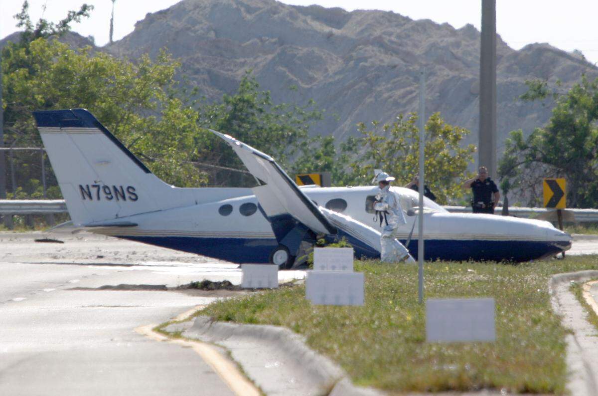 BROWARD 5/12/06 RC White / for the Miami Herald - Two men escaped injury when engine troubles forced a crashed landing of a twin engine plane on NW 62 Street just west of Fort Lauderdale’s Executive airport late Sunday afternoon. A leak spilled fuel onto the roadway but Fort Lauderdale Fire rescue took appropriate measures to prevent the spill from bursting into flames as happened with the DC3 in NE Fort Lauderdale last year.