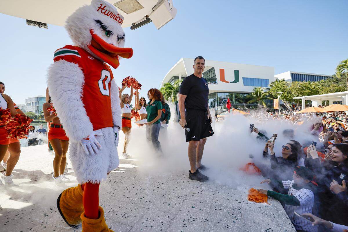 Miami Hurricanes head coach Mario Cristobal arrives on stage at the Miami Hurricanes Pep Rally at the Lakeside Patio at the University of Miami in Coral Gables, Florida, on Friday, January 16, 2026, as they celebrate the upcoming National Championship Game against the Indiana Hoosiers on Monday.  