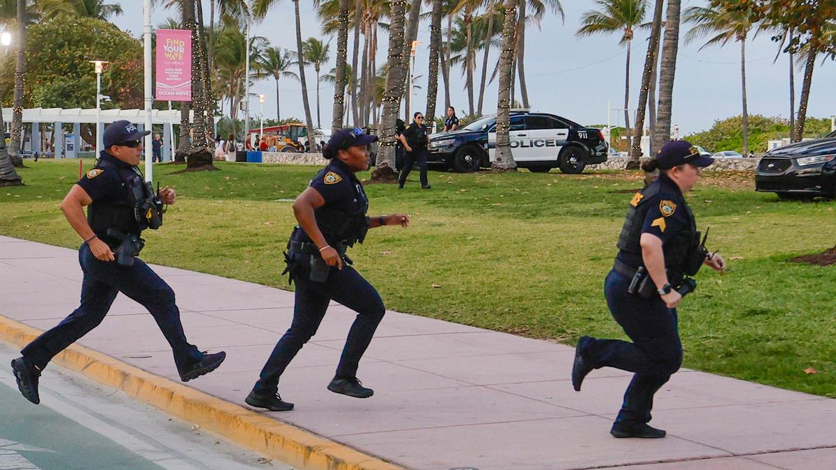 Miami Beach police officers rush to a call on Ocean Drive during spring break on Miami Beach, Florida on Saturday, March 16, 2024.
