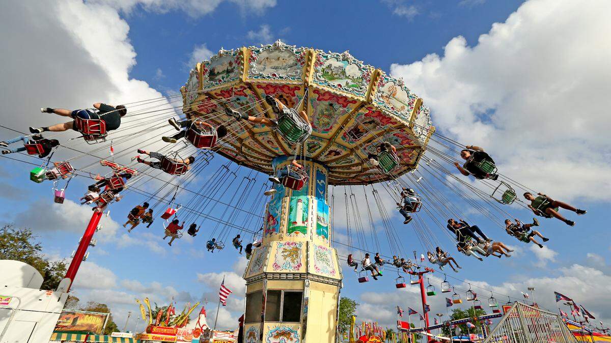 Fairgoers enjoyed the Wave swinger ride attraction during the opening of the Miami-Dade County Youth Fair at the Miami-Dade Fair & Expo Center on Thursday, March 14, 2019 in Miami.