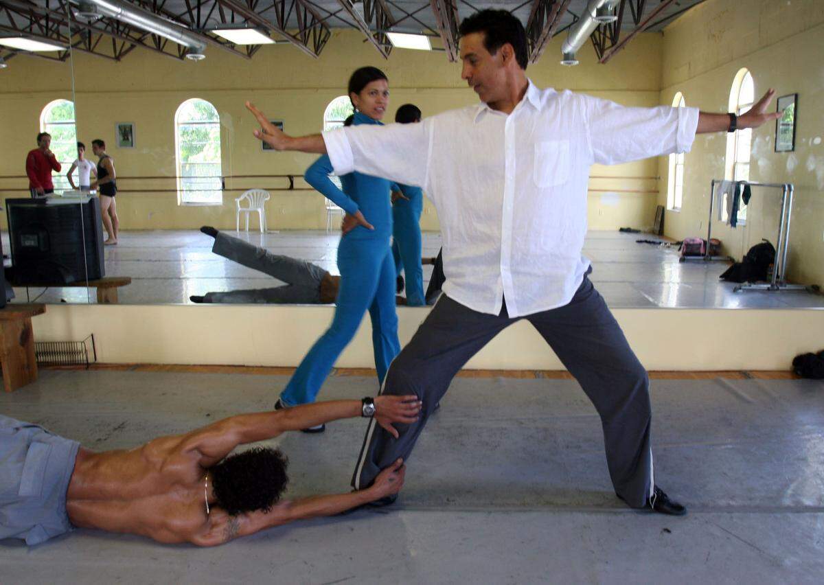 Artistic director Jimmy Gamonet de los Heros, center, worked with dancer, Isanusi Garcia Rodriguez, right, while dancer Iliana Lopez, back, observed during a rehearsal of Ballet Gamonet’s first program in this 2005 file photo.