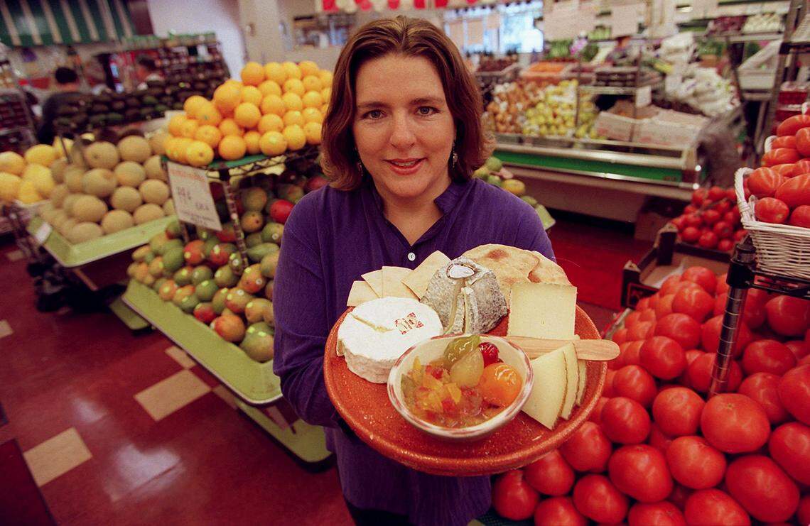 Sarah Freedman-Izquierdo of Epicure Market shows some of the cheese at the Miami Beach store in 2001.
