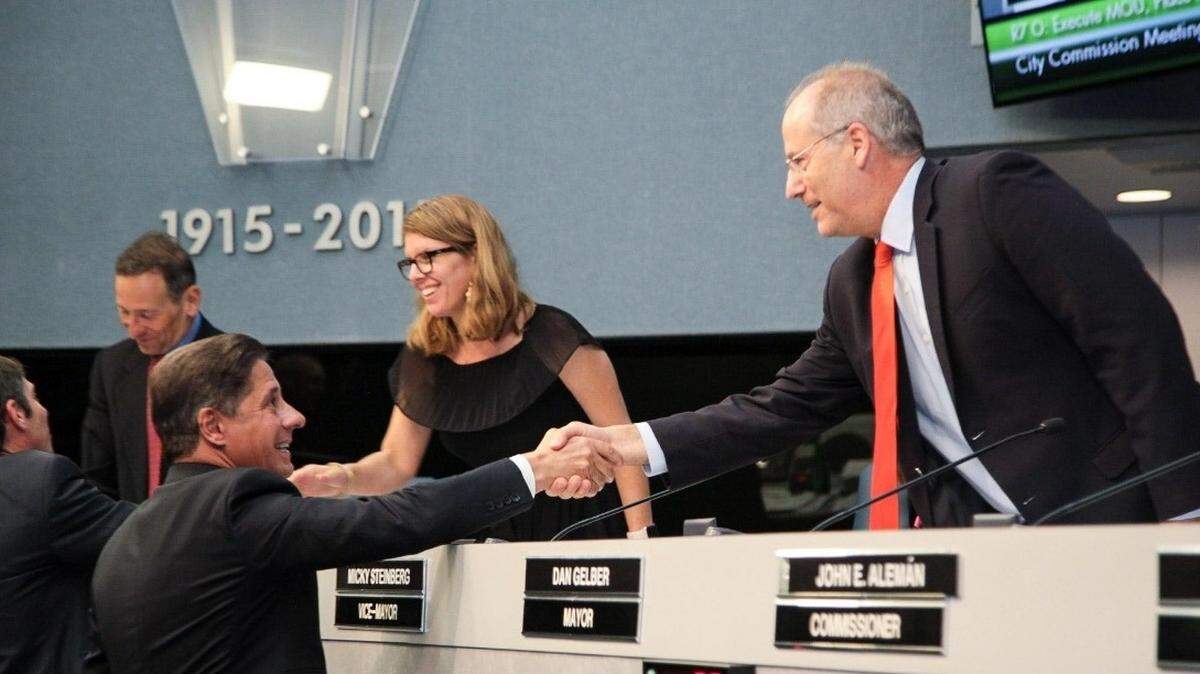 Miami-Dade Superintendent of Schools Alberto Carvalho shakes hands with Miami Beach Mayor Dan Gelber and members of the Commission on June 6, 2018, after the city and the school board agreed to assign Miami Beach police officers to all public schools in the city starting with the 2018-19 school year.