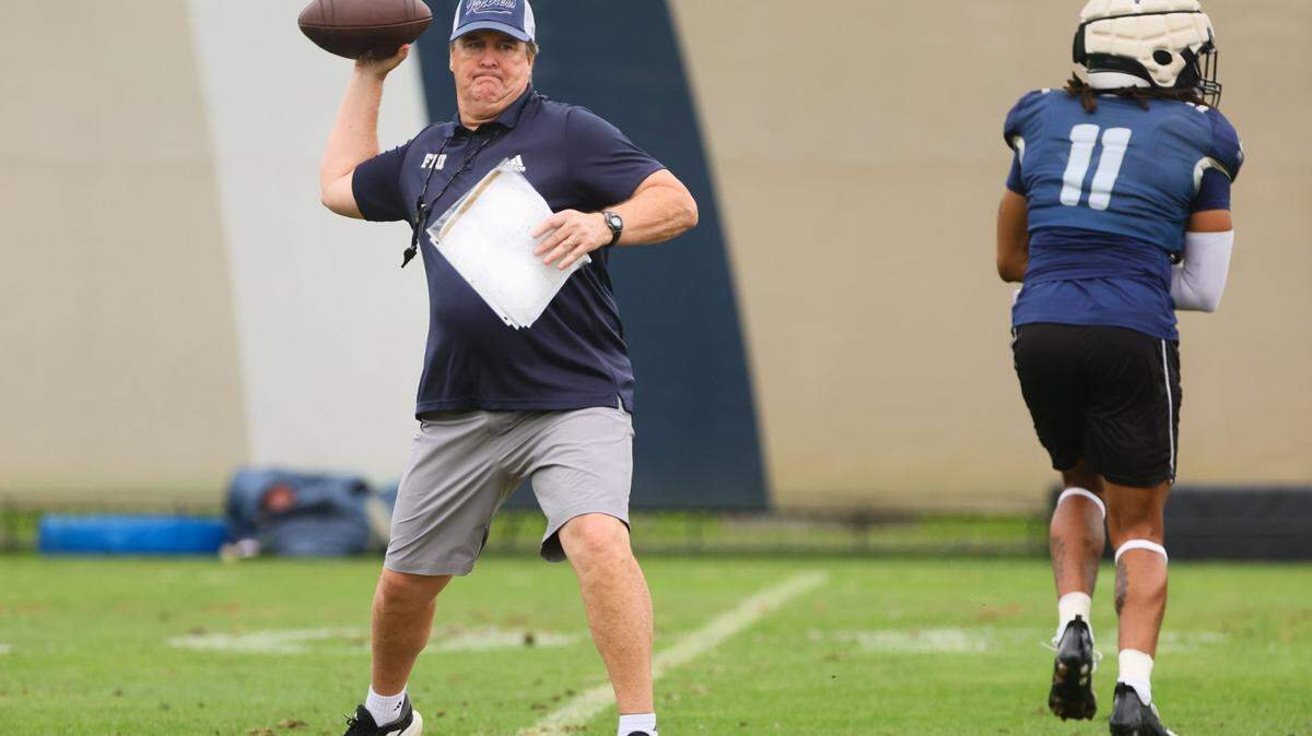 FIU Golden Panthers head coach Mike MacIntyre throws the football during practice at Florida International University in Miami, Florida, Thursday, March 28, 2024.