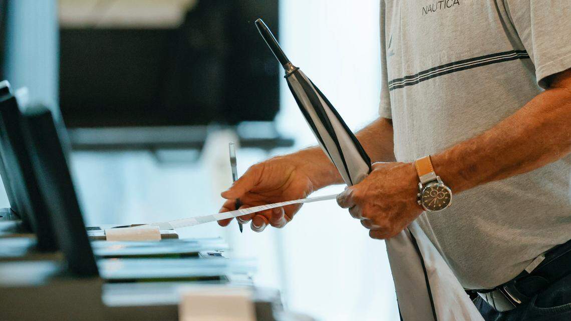 A voter deposits a ballot after voting during the Miami General Municipal and Special Elections in Miami-Dade County at the Jose Marti Gym on Tuesday, Nov. 2, 2021.