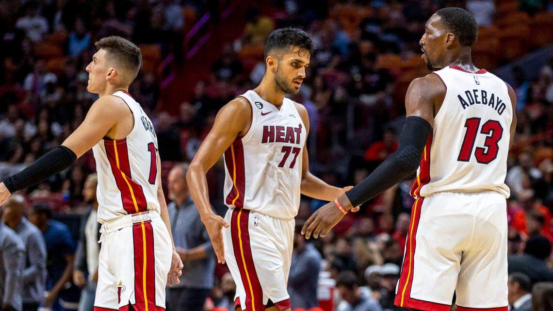 Miami Heat center Bam Adebayo (13) low-fives center Omer Yurtseven (77) during the first half of an NBA preseason basketball game against the Minnesota Timberwolves in Miami, Florida, on Tuesday, October 4, 2022.