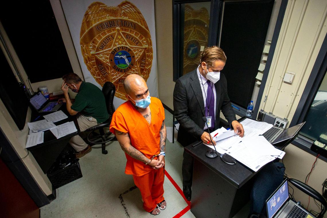 A jail inmate stands beside his legal counsel during a first-appearance hearing at Turner Guilford Knight Correctional Center in Miami late last year where his bond was set. Miami-Dade is expected to roll out a new bail reform effort later this year designed to make it easier for people accused of low-level crimes to get out of jail faster and at less cost.