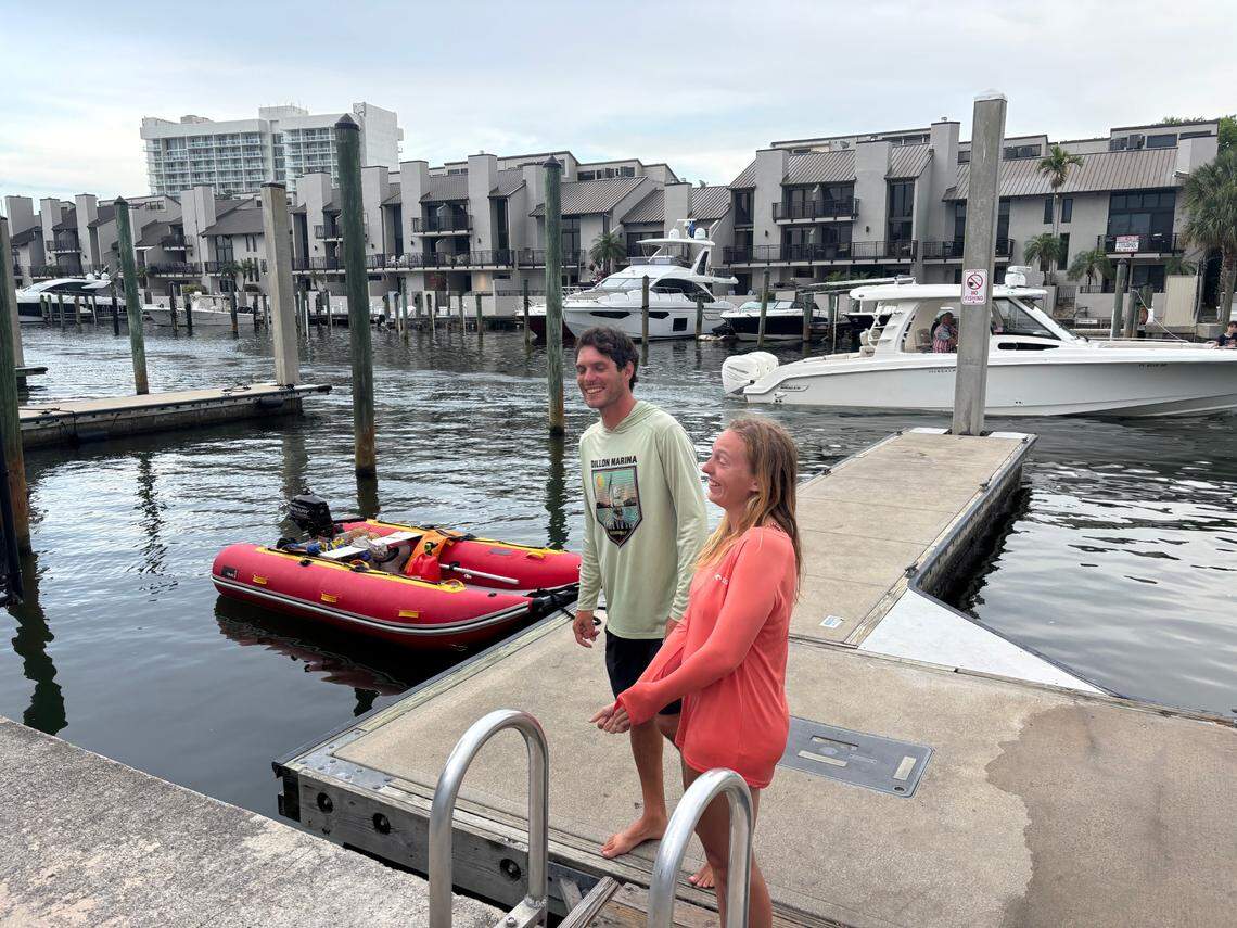 Bret Triano and Marisa Toomsen describe how they jumped into action to rescue a man after the boat he was on exploded in the Intracoastal Waterway in Fort Lauderdale on Monday, May 26, 2025. Triano and Toomsen brought the man to shore on the red dinghy pictured behind them.