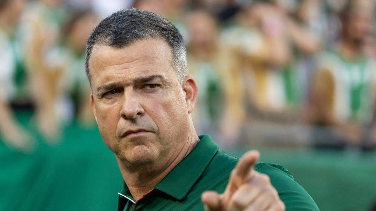 Miami Hurricanes head coach Mario Cristobal gestures as he makes his way to the locker rooms before the start of his NCAA college football game against the South Florida Bulls at the Raymond James Stadium on Saturday, Sept. 21, 2024, in Tampa, Fla.
