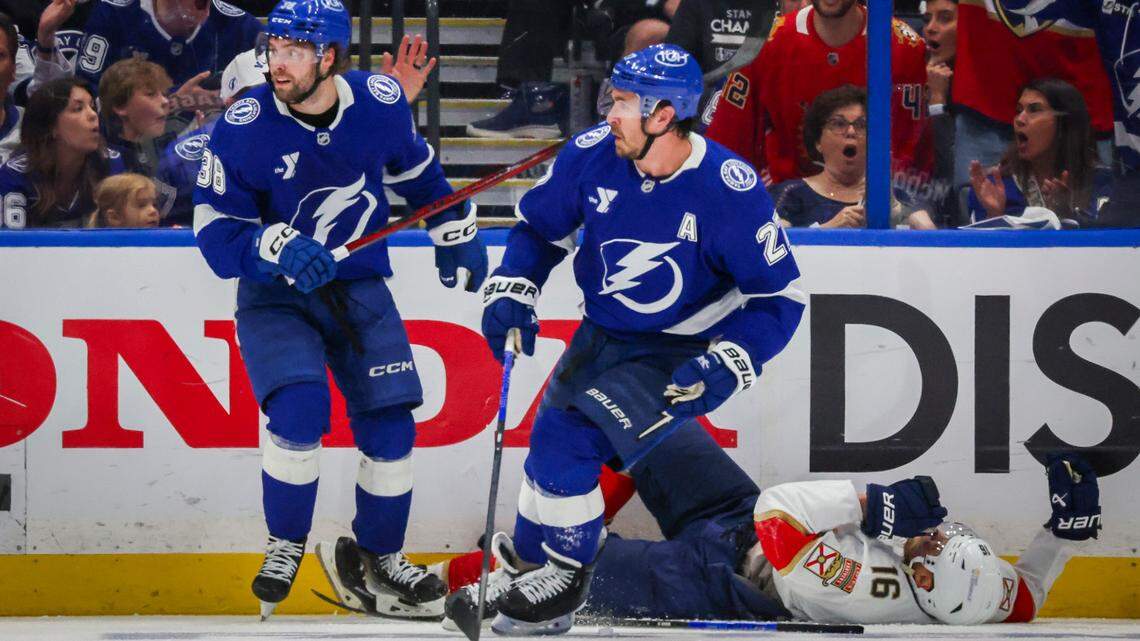 Tampa Bay Lightning left wing Brandon Hagel (38), left, looks around after hitting Florida Panthers center Aleksander Barkov (16), right, while Tampa Bay Lightning defenseman Ryan McDonagh (27) looks on during the third period in Game 2 of the first round in the Stanley Cup Playoffs Thursday, April 24, 2025 in Tampa. Hagel received a five minute penalty for interference.