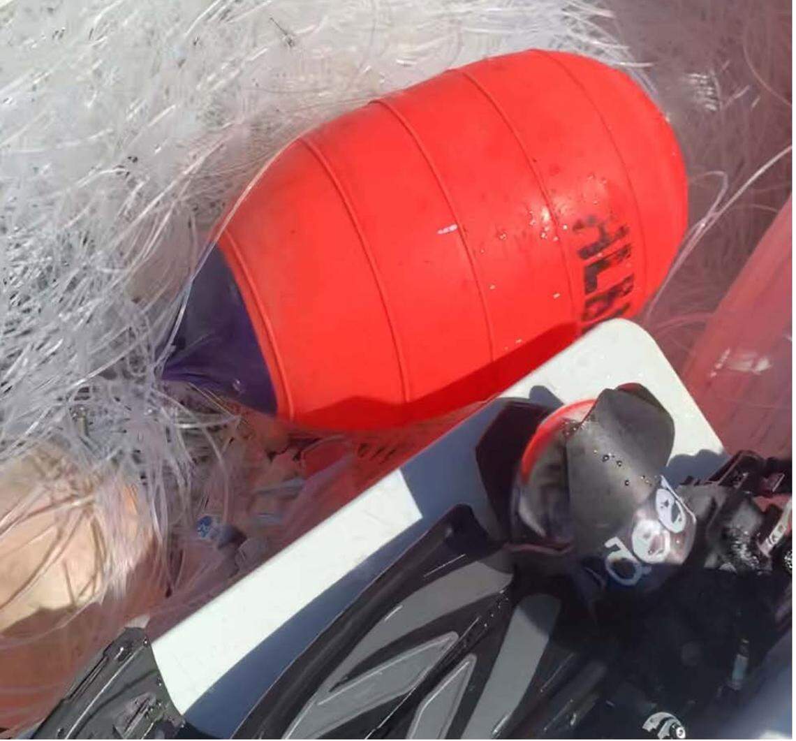 An orange buoy is placed with bunched-up monofilament fishing line. John Moore, Jr., a shark diver who federal agents accuse of steeling commercial longline gear, said the buoy was the only marker attached to the fishing line he’s accused of taking.