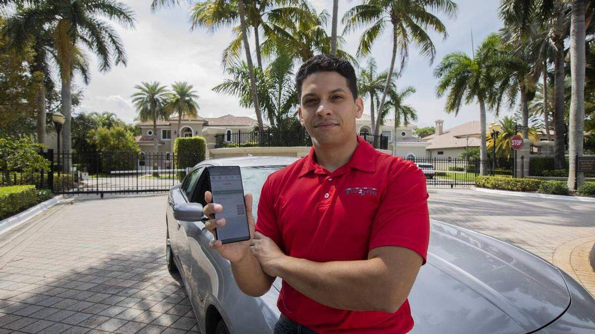 Steven Tamayo, co-founder of Boca Raton-based startup Tap2Open, stands in front one the type of gated community that serves as the tech startup’s customer base.